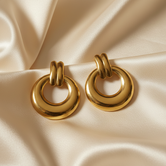 Gold door knocker earrings on silk