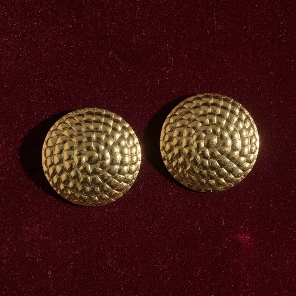 Gold scale dome earrings on burgundy velvet